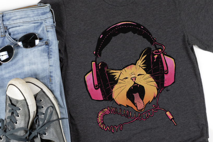 A cat sings super loud while wearing a pair of unplugged headphones. Tee shirt mockup.